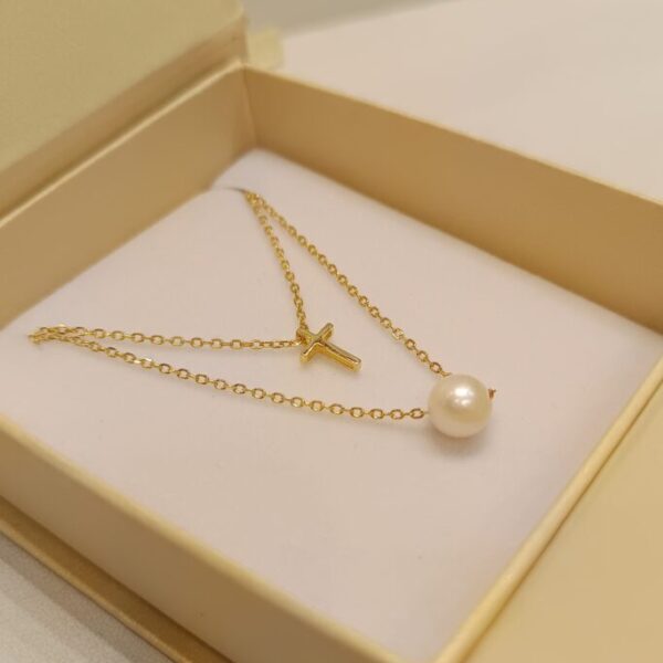 Conjunto doble con perla y cruz